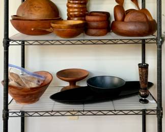 Display Shelf Featuring,:  Top- Brown Glaze Pottery Pitcher, Wood Liqueurs (set of six), Wought Iron and Wood 5-Arm Candelabra, Vintage Wood Butter Mold , Old Sarum Kettle Dalton Pottery for Watson & Co.Salisbury England 
Shelf 2: Teak, etc. Wood Bowl Collection
Shelf 3: Acacia Wood Salad Bowl, Wood Pedestal Bowl, David Douglas Accalac Plastic Salad Bowl and Mid-Centey Acca Accalac Black Plastic 28”long  Bowl
Shelf4: Mid-Century Butterfly & dried Floral Seving Tray & 4 small Pictures, a light ting Rod Glass Ball and Direction Arrow