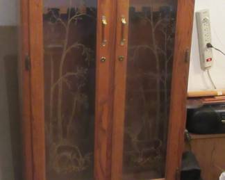 Oak style 8 gun storage cabinet with roll up storage.