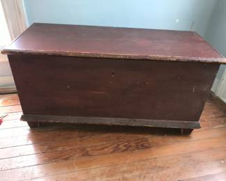 Antique blanket chest in old red paint.