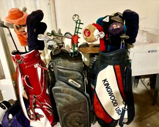Assorted golf clubs and bags