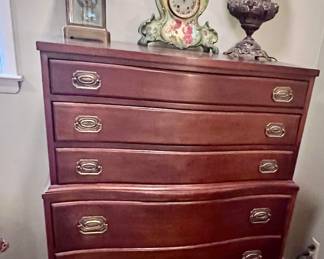Tall dresser with globe lamp, & two clocks