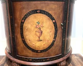 A floral detailed, demi globe cabinet.