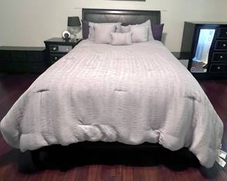 Queen sized bed with linens