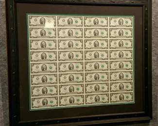 Framed uncut sheet of $1 bills.