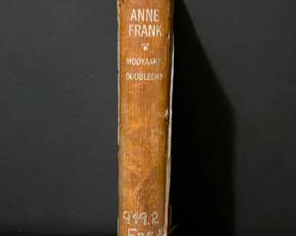 Book,  Anne Frank, a diary of a young girl from 1952 and was once in the library of Corsicana ISD's Collins Jr High. 