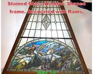 Lot 508 Large Antique Leaded Stained Glass Window. Shaped frame. Decorated with Rams. 