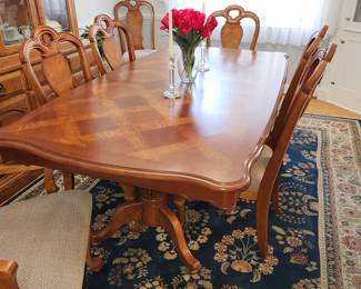 Table measures: 82" long (with one 13" leaf inserted) x 43" wide. Table w/ 2 13" leaves, 8 chairs (2 w/ arms) and pads. Dining table with chairs and china cabinet are AVAILABLE FOR PRE-SALE. Please contact us for pricing.