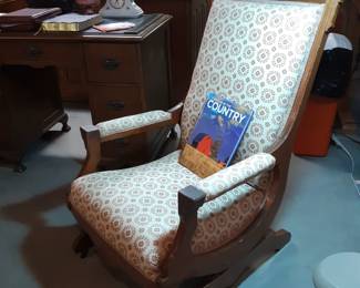 This antique rocking chair is upholstered with the same fabric as the oak dining chairs.