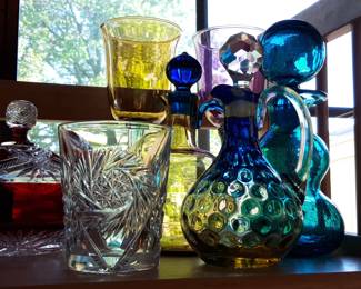 Beautiful glass pieces are in the dining area in front of sliding glass doors.