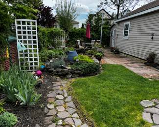 Back yard, full of treasures and gnomes, umbrella sold