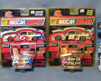 Diecast Assortment Of Toy Cars Including, Toys R Us NASCAR Special Edition Bruce Lee Car, The Originals Racing Champ's NASCAR Mark Martin, Finger Skate Boards, And More, Contents Of Flat