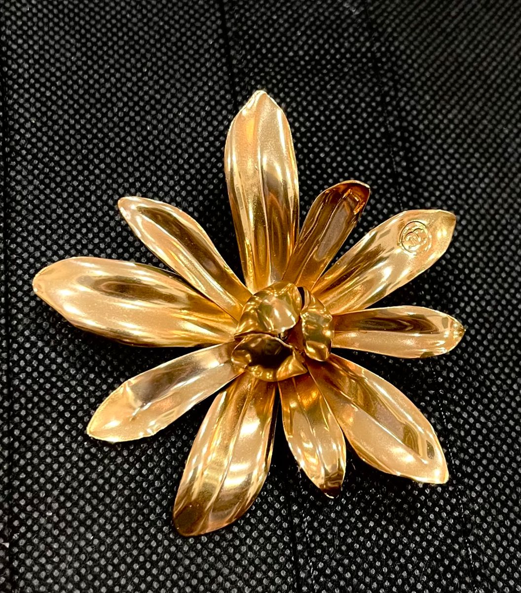 Chanel. This gold-tone sublimage brooch truly is beautiful.
