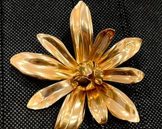 Chanel. This gold-tone sublimage brooch truly is beautiful.