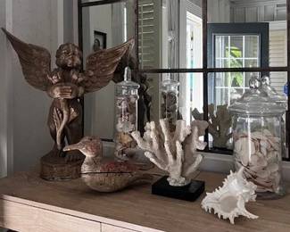 Wood carved angel with glass eyes, wooden duck decoy, coral and shells