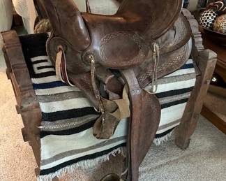Vintage wester trail horse saddle with carved wooden stand