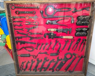 Antique tool collection in shadow box. 