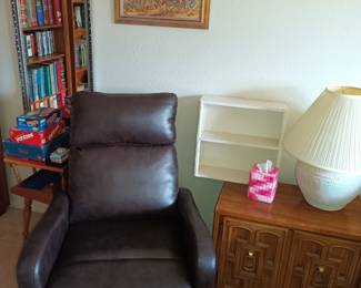 Recliner, games, lamp and nightstand.