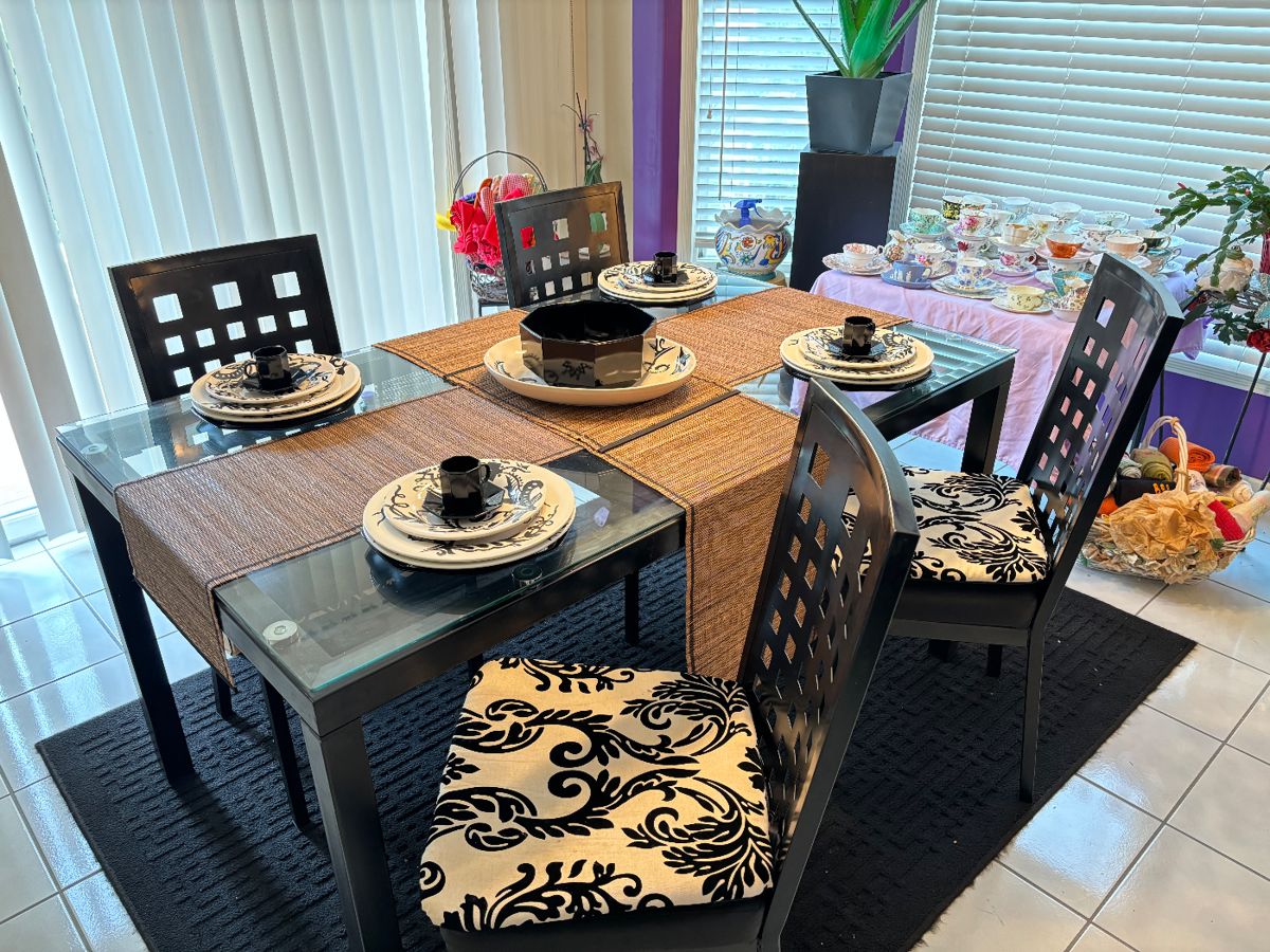 Elegant glass top kitchen / dining table with 4 chairs. Option of pattern chair cushions or black