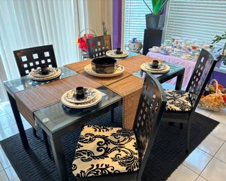 Elegant glass top kitchen / dining table with 4 chairs. Option of pattern chair cushions or black