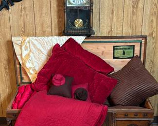 Antique hope chest, clock, quilt, pillows