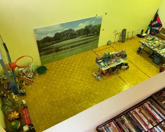 Sneak peak from the main floor of the full size racquet ball court that has lots of goodies including Christmas items, new in box toys, and stunt kites!