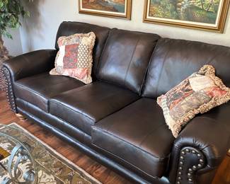 Large bonded leather sofa with nail head trim, black.  Condition is fair and priced accordingly