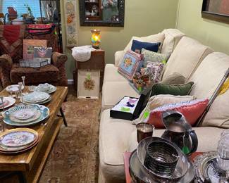 Den staged with lovely couch, needle point pillows and more