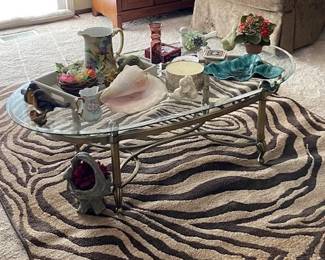 Zebra print floor rug, glass and metal coffee table