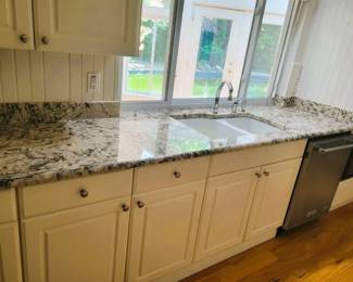 Countertops, cabinets, stainless dishwasher