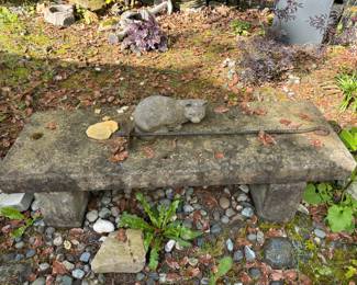 Garden bench and statuary cat