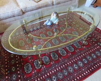 Oval galss and brass coffee table.