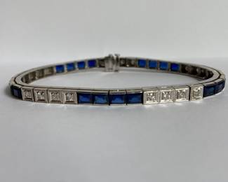 14k white gold twenty .03 karat each Round Brilliant Cut diamonds and twenty 4 mm x 4.7 mm each Emerald Cut synthetic sapphire tennis bracelet