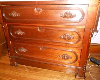 This dresser has a white marble top,