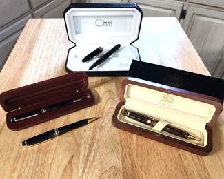 Lower left -2 Mont Blanc Meisterstuck ball point pens Lower right - a Bueche-Girod ball point pen                                Rear - An Omas/Levenger 14K nib black pen 