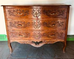 Antique Walnut Louis XV Provincial French Style Commode / Chest of Drawers

Commode / chest of drawers, solid-stock walnut. Features bronze Rococo pulls and escutcheons, serpentine three-drawer front and skirt;

drawer faces and case sides recessed-carved with floral; front and rear cabriole legs

Louis XV provincial, French style, mid-18th century

Item in antique condition with some wear including; warping to top, replaced lower section of skirt, numerous shrinkage cracks, nicks, indentations and worm holes; hardware replaced.

Measures 41 inches high by 51 inches wide by 24 inches deep.