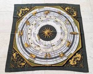 Hermès Black and Gold Zodiac Scarf. There is a small spot that is not overly noticeable.

Measures 34” x 34.5”.
