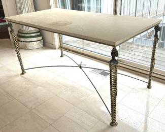 Nefertiti Table by Mario Villa 

Custom made table by Mario Villa. Patinated wrought steel and brass table with hard stone top, caryatid legs, X stretcher and dragon finial. The brass wrapped legs are accompanied by a steel crossbar and steel frame. The middle center is accented with a brass knot and dragonfly figurine. Some sun fade and water spots on the surface. 

Measures 60" x 30" x 29". This one of a kind designed table is signed by the artist