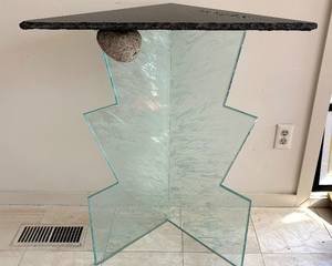 This "Hours" Artisan Made Accent Table features a granite top with distressed glass and a rock underneath for added beauty! Such an interesting work of art! 

Measures 35 inches tall and the top measures 30 x 22 x 21 inches. It features a granite top with a distressed glass and a rock underneath for added beauty! Such an interesting work of art! 