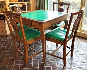 Antique Regence Game Table with Four Antique Neoclassical Accent Chairs. Crafted in solid-stock wood, later leather top, Regence design, Continental – probably French provincial style/design (chairs are stamped Made in Italy)

Beautiful early 18th century; square top with two drawers, relief-carved shell and foliage apron and cabriole legs and hoof feet.

In vintage condition with a dry finish, joint separations, numerous wormholes, nick, scrapes and indentations.

Measures: 28 inches high by 29 ½ inches wide by 29 ½ inches deep