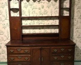 Antique Oak and Mahogany Veneer English Dresser in two parts with scrolled cornice, plate shelves flanked by two cabinet doors. 

The base has two cabinet doors flanked by three drawers. Original pierced stamped brasses. 

English, Circa 1800

Measures about 87 inches high by 77 inches wide by 19 inches deep
