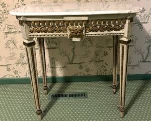 Antique Neoclassical Style Painted Wood Table features dental molding, faux bronze mounts, square tapering legs and replacement marble top. 