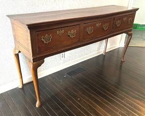Antique English George II Serving Table

Lovely serving table (dresser), solid-stock oak, pierced “batwing” brass pulls and escutcheons

English, George II, mid-18th century. Features rectangular top, three (3) drawers, and cabriole legs

Item in antique condition with some wear including; warped-split top, numerous nicks and indentations – mostly to outer edges and legs and case sagging

Measures; 35 inches high by 70 inches wide by 18 inches deep.
