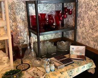 Ruby red glassware & others, glass snack sets with cups, large glass platter & large cut glass bowl; on table in front of glassware on table, Fenton s/p shakers & small container - all match; bowl with glass marbles, knife & steak knife sets, pie plate & vintage dish