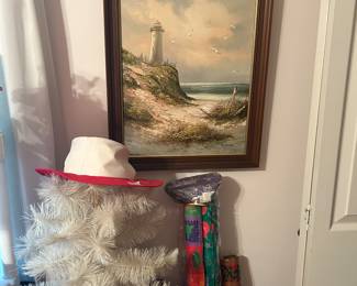 Framed picture above white tree with hat & wrapping paper