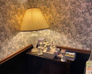 Precious moments figurines - most with boxes, lamp, and Previoys Moments book & phamplet- all in top of small glass door cabinet/chest