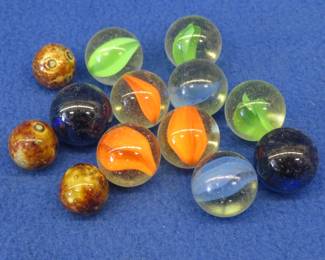 Lot 156. Ten shooter and three vintage clay marbles in a {#}4 Blue Ball jar