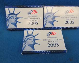 Lot 398. Three 2005 US Mint proof sets. Each set contains regular circulation coins and a state quarter coin set for 2005.