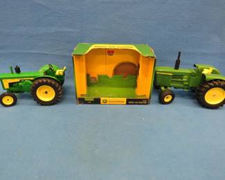 Lot 48. Two die-cast John Deere tractors.:
