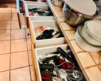 Packed kitchen—tools, linens, glassware.