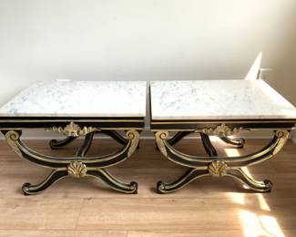 A pair of marble top tables with stylized X form bases.